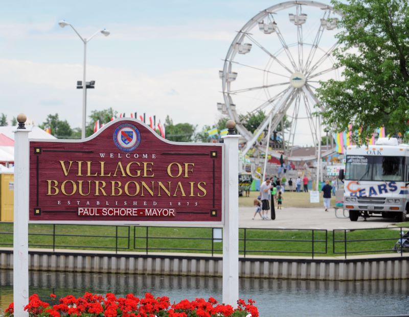 Welcome to Bourbonnais, Illinois sign outside in front of ferris wheel