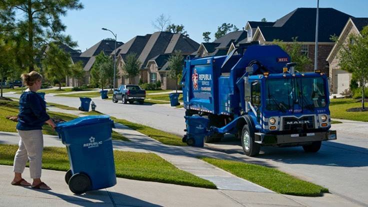 republic garbage truck during trash pickup with resident